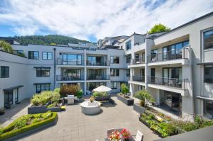 an exterior view of a building with a courtyard at The Glebe Apartments in Queenstown