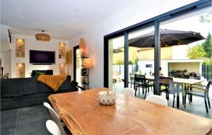 a living room with a table and a dining room at 3 Bedroom Amazing Home In Montfavet in Montfavet