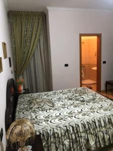 a large bed in a room with a window at Deluxe & Big Appartment City center in Fier