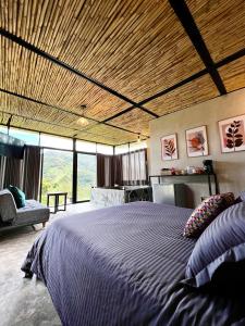 a bedroom with a large bed with a wooden ceiling at Santa Helena in Chinácota