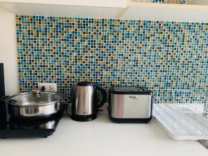 a kitchen counter with pots and pans on a counter top at คอนโดบ้านเพียงเพลิน หัวหินby Nicha in Hua Hin