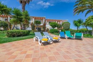 a group of chairs sitting on a brick patio at Casa Palmeira in Lagos