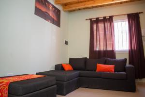 a living room with a couch and a bed at Aladdín Departamentos in Ciudad Lujan de Cuyo