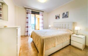 a white bedroom with a bed and a window at 2 Bedroom Amazing Apartment In Casares in Casares