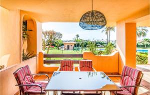 a patio with a table and chairs on a porch at 2 Bedroom Amazing Apartment In Casares in Casares