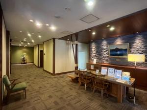a lobby with a table and chairs in a room at Shikotsuko Onsen Lake Side Villa SUIMEIKAKU-Adult Only in Chitose