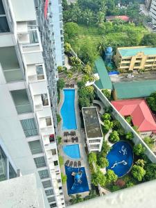 an aerial view of a building with two swimming pools at Cubao, Quezon City Condo Staycation (wifi and netflix ready) in Manila