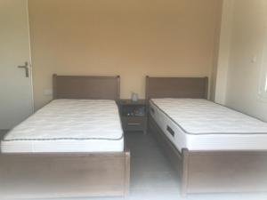 two beds sitting next to each other in a room at Georgiadis House in Ammoudia