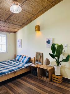 una camera con letto, tavolo e pianta di My Dream Hotel a Da Lat