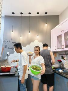 a group of people in a kitchen preparing food at Triple-T Homestay in Vung Tau