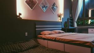 a bedroom with a bed with a headboard and a window at Triple-T Homestay in Vung Tau +17 photos