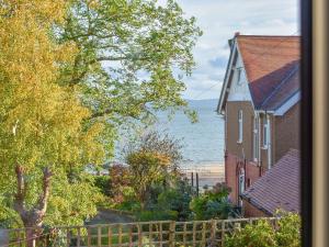 a view of the beach from a house at Sea View Cottage in Llandrillo-yn-Rhôs