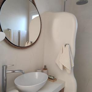 a bathroom with a white sink and a mirror at Nafplio Lodge in Nafplio