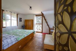 a bedroom with a bed and a window and a door at Mountain lake Island Cabin Sierra - for family Getaway in Cavinti
