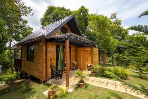 a wooden house with a pitched roof at Mountain lake Island Cabin Sierra - for family Getaway in Cavinti