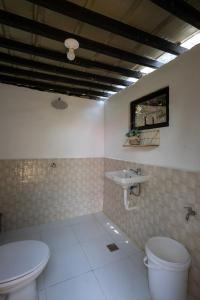 a bathroom with a toilet and a sink at Mountain lake Island Cabin Sierra - for family Getaway in Cavinti