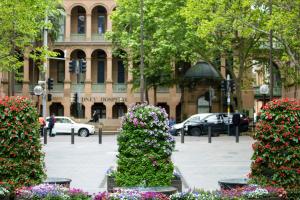 a group of flowers in front of a building at The Sebel Sydney Martin Place in Sydney