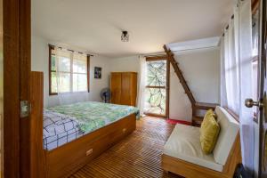 a bedroom with a bed and a window at Mountain lake Island Cabin Sierra - for family Getaway in Cavinti