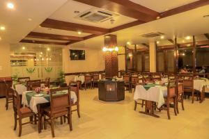 a dining room with tables and chairs in a restaurant at Bharatpur Garden Resort in Bharatpur