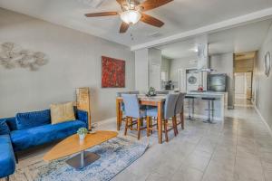 a living room with a blue couch and a table at Close to All, Restful Duplex A in Downtown, UTEP, Hospitals in El Paso