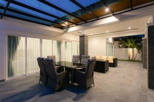 a dining room with a table and chairs at Orchid Paradise Homes OPV428 in Hua Hin