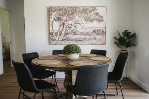 a dining room with a wooden table and chairs at Figo Place in Benalla