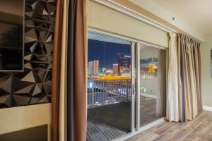 a room with a large window with a view of the city at 2100 SqFt Penthouse Suite W/ Strip Views! POOL GYM in Las Vegas