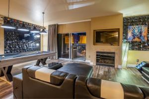 a living room with a pool table and a couch at 2100 SqFt Penthouse Suite W/ Strip Views! POOL GYM in Las Vegas