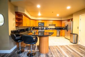 a kitchen with a large island with two bar stools at 2100 SqFt Penthouse Suite W/ Strip Views! POOL GYM in Las Vegas