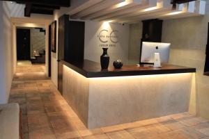 a lobby with a counter with a laptop on it at Hotel Casa Cantera in Oaxaca City