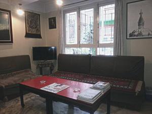 a living room with a couch and a table at Imperial House Thamel - 2 km from Swayambhunath Temple in Kathmandu