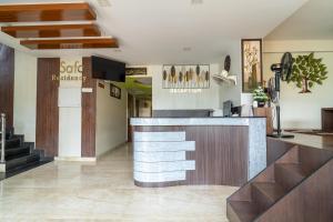 a lobby of a hotel with a reception counter at Safa Residency in Tiruchirappalli