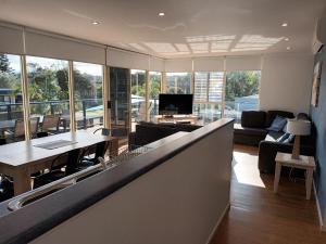 a living room with a couch and a table at Grandeur Holiday Units in Merimbula