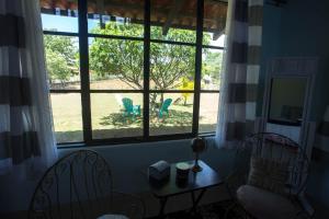 a room with a window with chairs and a table at Two Acre Private Costa Rican Villa Volcano Views Gym Hot Tub in Atenas