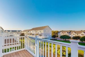 a balcony with a white railing and houses at Seaside Village 13007 #2 in Ocean City