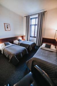Posteľ alebo postele v izbe v ubytovaní Hotel Centrum