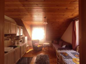 a kitchen and living room in a log cabin at Rajski Staw in Zajki