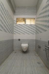 a bathroom with a toilet and a window at Hotel great punjab in Aurangabad