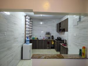 a kitchen with a refrigerator and a counter in it at Peace homes in Nairobi