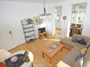 a living room with a couch and a table at Villa Sanssouci - Apt. 02 in Ostseebad Sellin