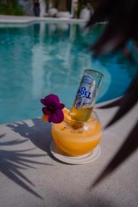 a drink in a bowl next to a swimming pool at Montagne Boutique in Kampot