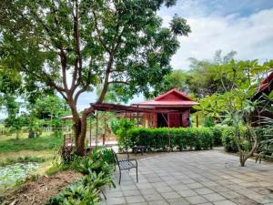 a pavilion with a table and chairs on a patio at The Green Vale B&B in Ban Na Chaliang