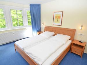 Postel nebo postele na pokoji v ubytování Villa Vilmblick - Wohnung 23 mit Meerblick-Balkon