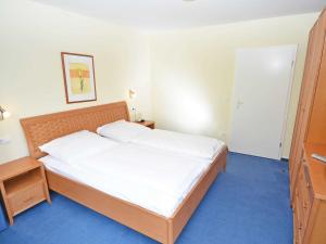 Postel nebo postele na pokoji v ubytování Villa Vilmblick - Wohnung 23 mit Meerblick-Balkon