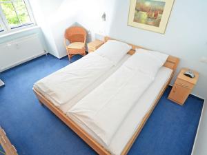 Postel nebo postele na pokoji v ubytování Villa Vilmblick - Wohnung 23 mit Meerblick-Balkon