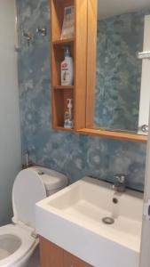 a bathroom with a sink and a toilet and a mirror at AniS Homestay 2 @ Nilai in Nilai
