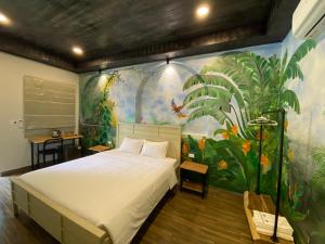 a bedroom with a large bed and a mural at Cerf Volant Soc Son in Sóc Sơn +64 photos
