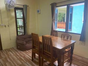a dining room with a table and chairs and a couch at 2 Bed Sunset Seaview Good View House Y in Ko Yao Noi