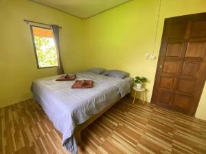 a bedroom with a bed with a tray on it at 2 Bed Sunset Seaview Good View House Y in Ko Yao Noi
