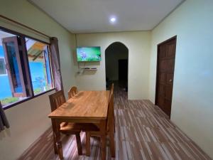 a dining room with a wooden table and chairs at 2 Bed Sunset Seaview Good View House Y in Ko Yao Noi